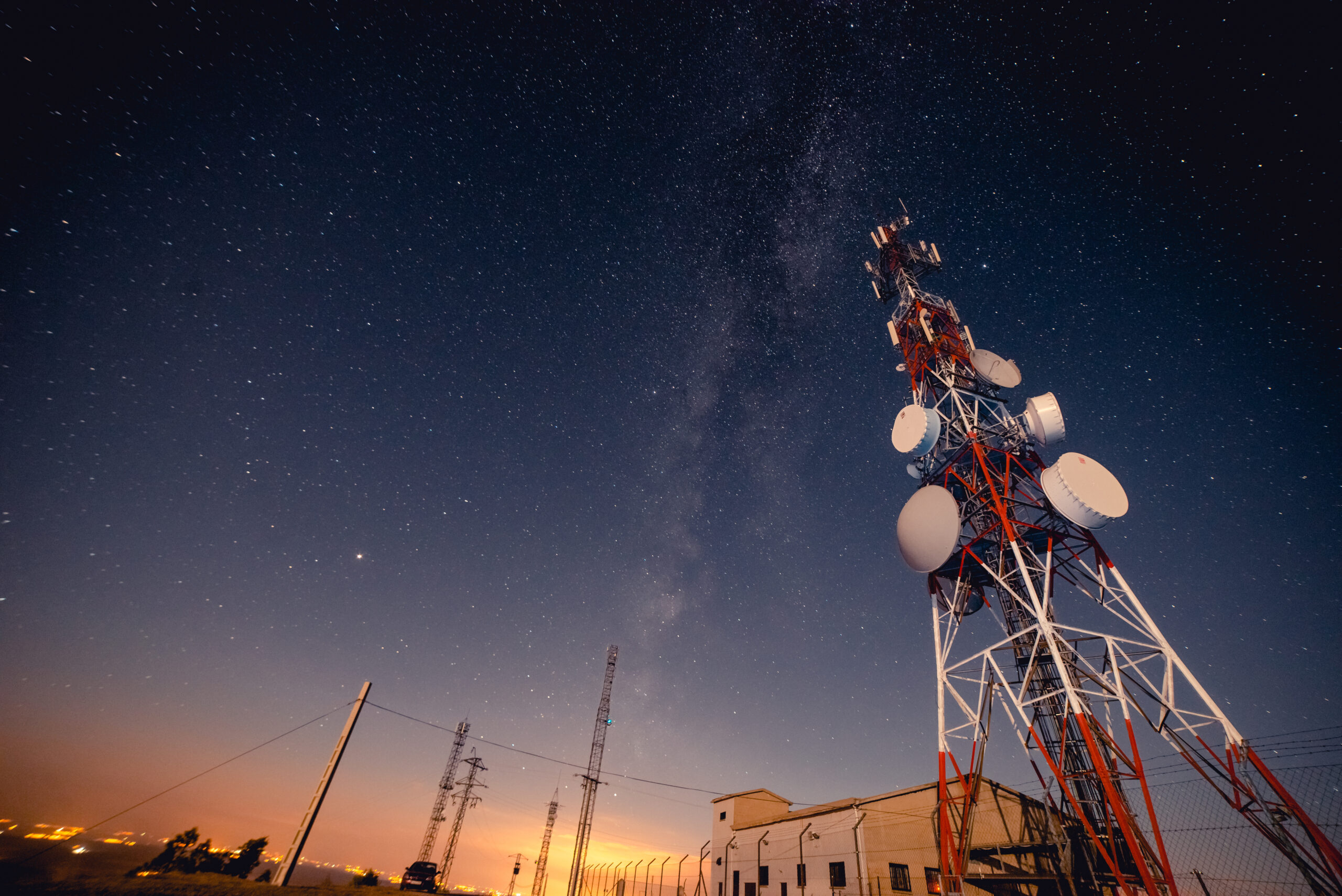 Government communications tower against a starry night sky
