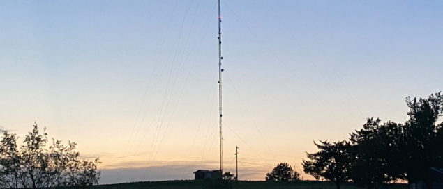 Communications tower silhouetted against a dusk sky
