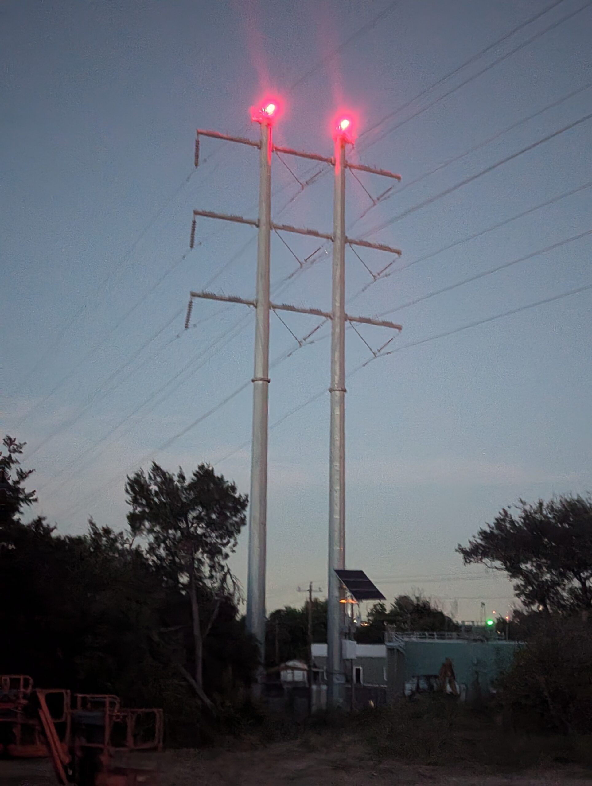 Solar-powered FAA obstruction lighting on an electric transmission structure at night